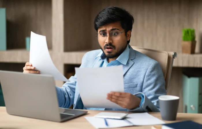 Man Checking Income Tax Notice Of Assessment