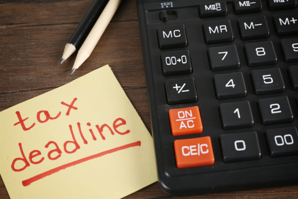 Tax filing deadline note beside calculator representing income tax scrutiny and assessment